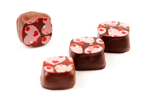 four chocolate bonbons isolated on white background