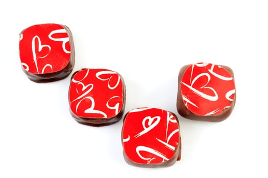 four chocolate bonbons isolated on white background