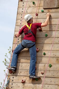 man is on climbing wall in the nature