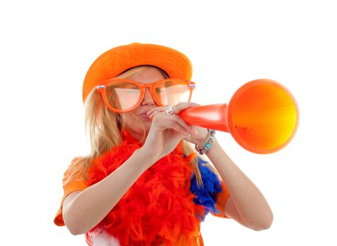 Portrait of dutch soccer fan in orange outfit with horn over white background