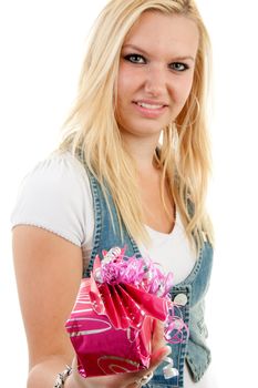 Young blonde woman is giving present, with focus on present and woman in blur, over white background