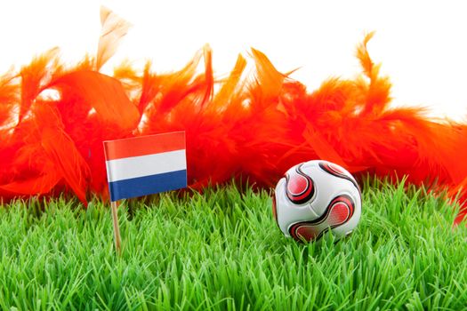 ball and Dutch flag on soccer field over white background
