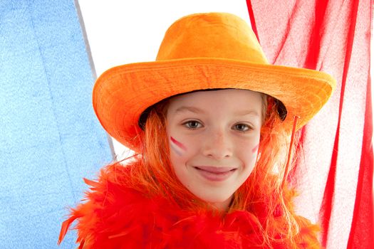 Young Dutch soccer supporter in orange outfit against the Netherlands flag
