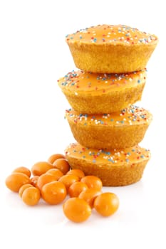 Pile big orange cake cookies and peanuts for Dutch soccer with confetti over white background