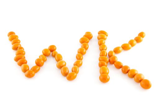 Word WK in orange peanuts isolated on white background