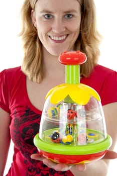 woman is holding colorful playtoy in closeup over white background