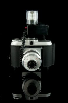 old fashioned photo camera isolated on black background