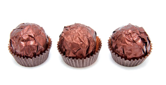 Three chocolate bonbons isolated on white background