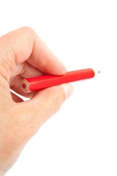 hand is holding red pencil and writes over white background