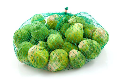 Net with Brussels sprouts isolated on white background