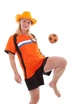 Female Dutch soccer supporter kicks ball over white background