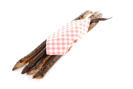 pile of Dutch smoked eel under napkin isolated on white background