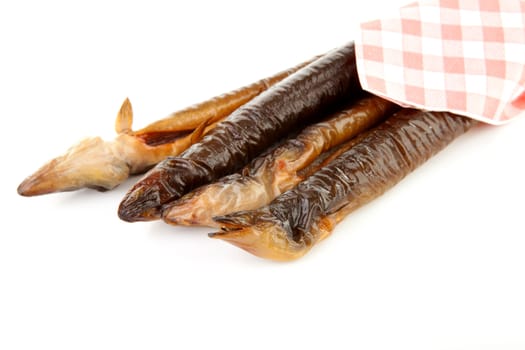 pile of Dutch smoked eel under napkin isolated on white background