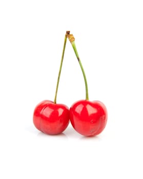 two fresh red cherries isolated on white background