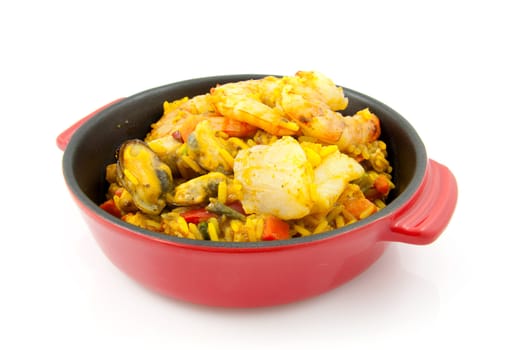 little casserole with paella and sea food over white background