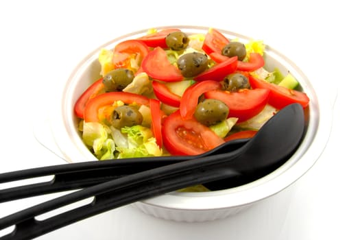 Bowl with fresh salad over white background
