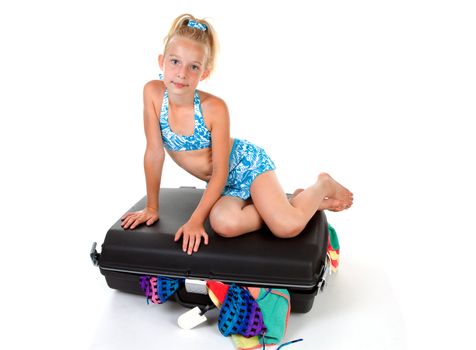 young child on stuffed suitcase over white background