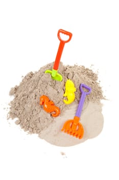 plastic toys for beach and vacation on sand over white background
