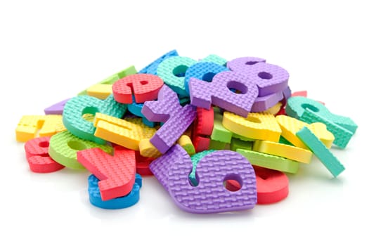 Stack of colorful foam letters over white background