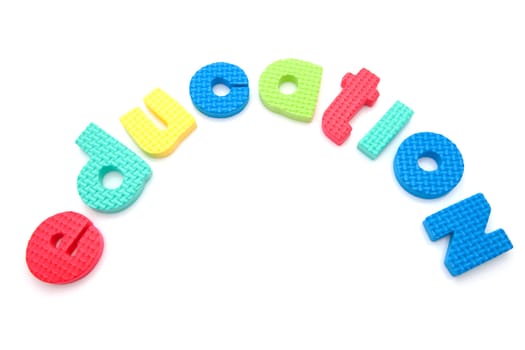 Word education in colorful foam letters over white background