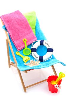beach chair with colorful towels and toys over white background