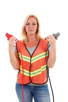 Woman in safety vest holding car jumper cables over white background