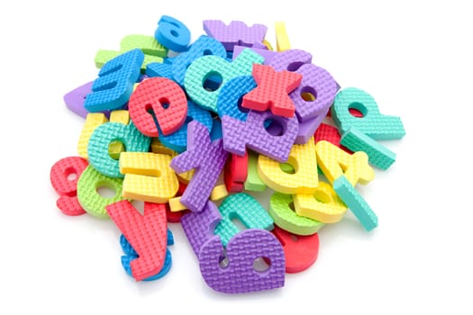 Stack of colorful foam letters over white background