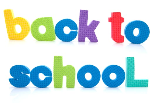 Sentence Back to school in colorful foam letters over white background