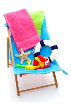 beach chair with colorful towels and toys over white background