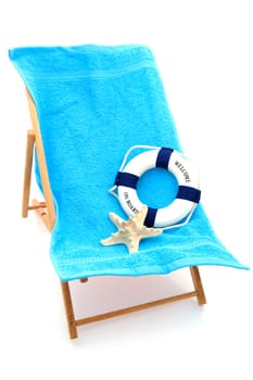 beach chair with colorful towel and life buoy over white background
