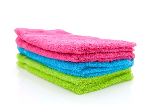 stack of colorful towels isolated on white background
