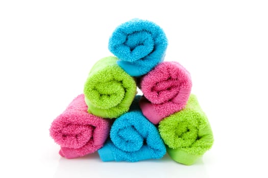 stack of colorful rolled towels isolated on white background