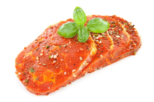 raw juicy steaks with herbs isolated on white background
