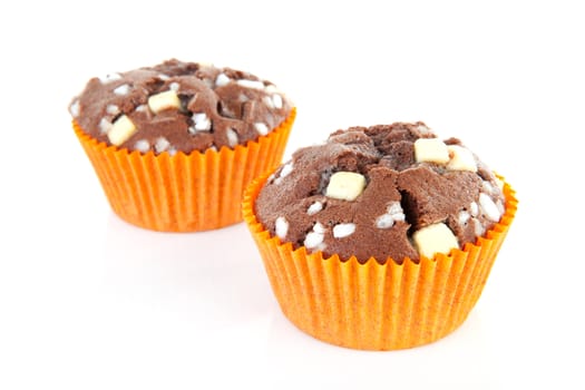 two brown home baked cupcake with chocolate pieces isolated on white background