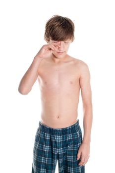 Sleepy teen in his pajamas.  Isolated on white.