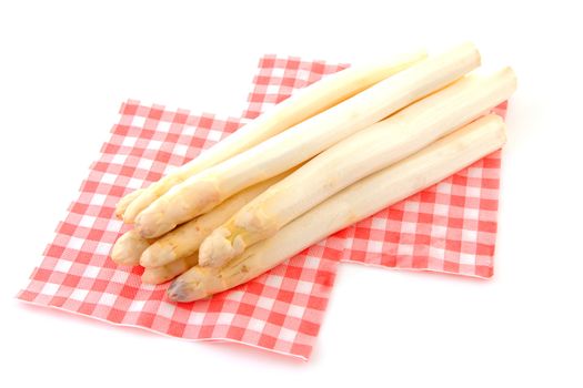 Bundle of fresh Dutch asparagus on napkin over white background