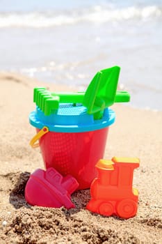 colorful plastic toys at the beach near the ocean