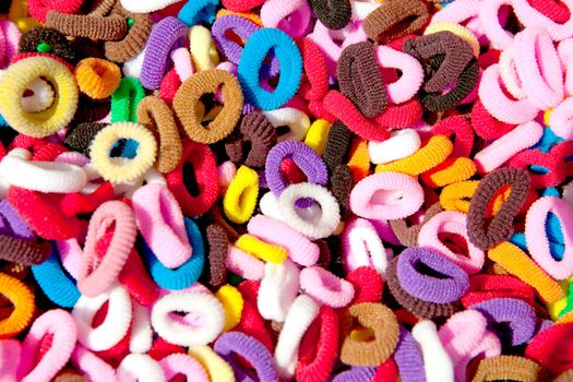 background of colorful hair elastics in closeup
