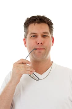 isolated man in white t-shirt is holding glasses in mouth