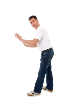 isolated man in white t-shirt is leaning or pushing nothing and looking in camera