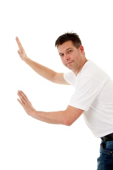isolated man in white t-shirt is leaning or pushing nothing and looking in camera