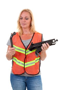 Woman in safety vest holding car breakdown jack over white background