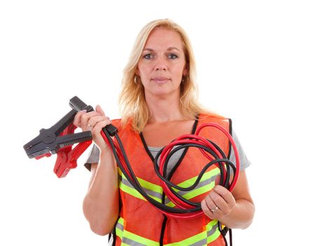 Woman in safety vest holding car jumper cables over white background
