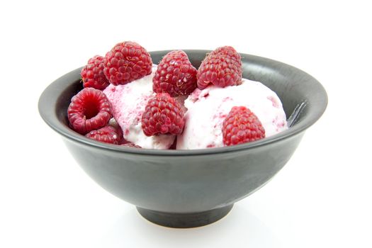 Bowl with desert, ice cream and raspberries isolated on white background
