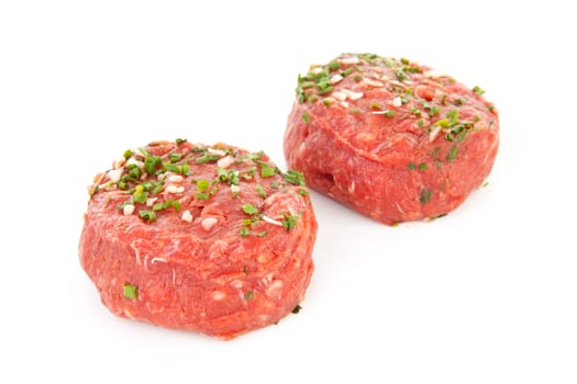 two raw German beef steak isolated on white background
