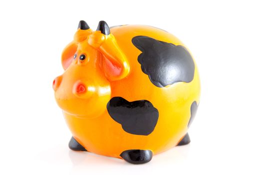 piggy bank in the shape of orange cow isolated on white background