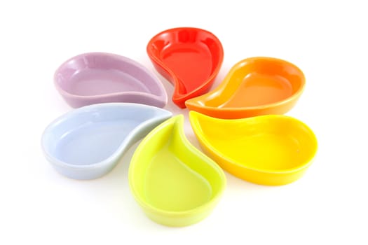 colorful empty little bowl in funny shape like flower over white background