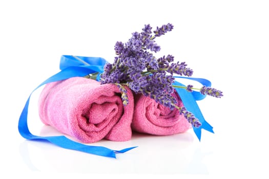 spa accessories with lavender and pink towels over white background