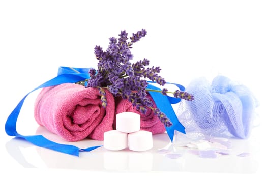 spa accessories with lavender and pink towels over white background