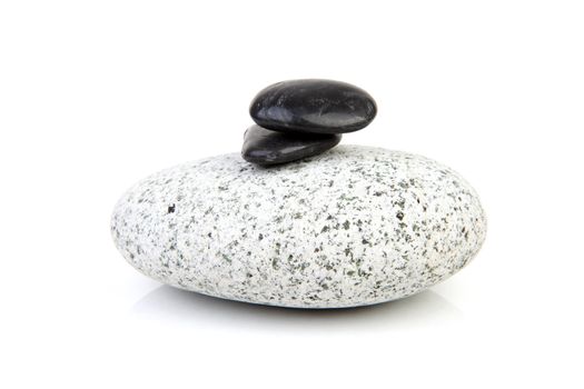 big grey rock with little back ones on thop over white background